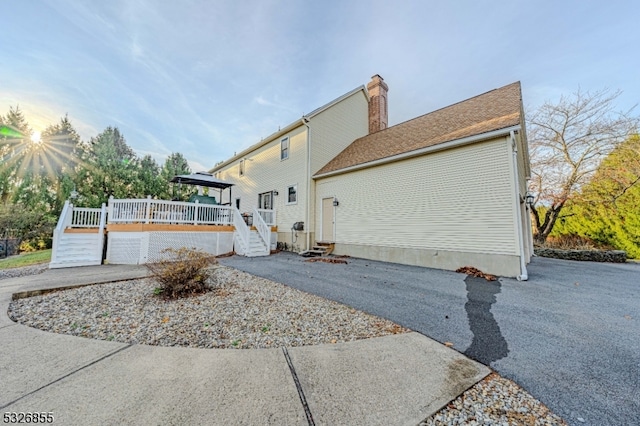 view of side of home featuring a wooden deck