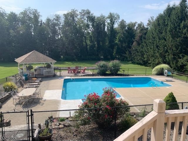 view of swimming pool with a gazebo, a patio, and a diving board