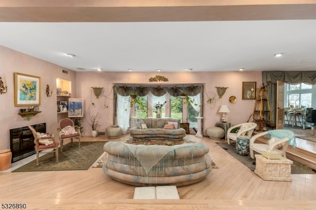 living room featuring plenty of natural light and light hardwood / wood-style floors