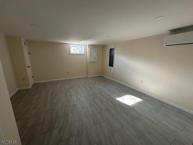 basement featuring a wall mounted air conditioner and electric panel