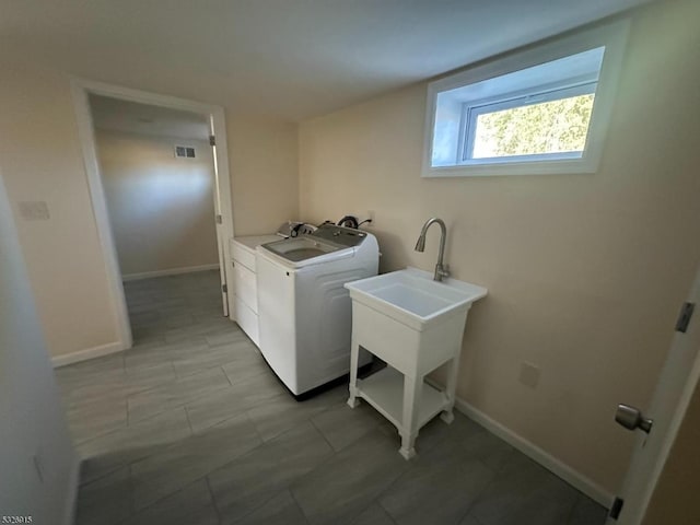 laundry room with washer and clothes dryer and sink