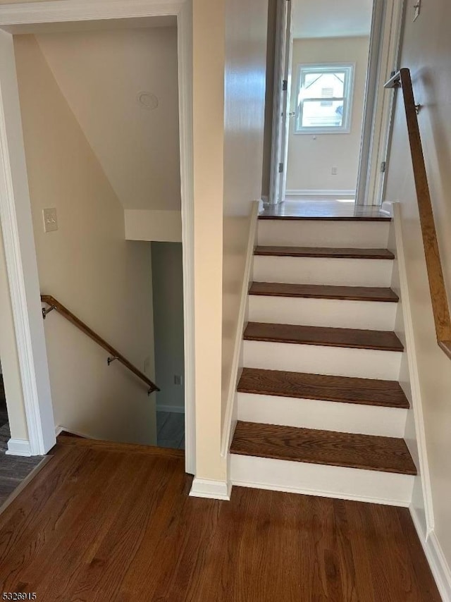 stairs with wood-type flooring