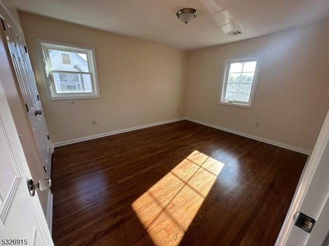 spare room with dark hardwood / wood-style floors