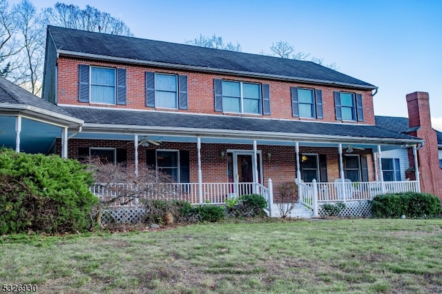 view of front of home featuring covered porch and a front yard