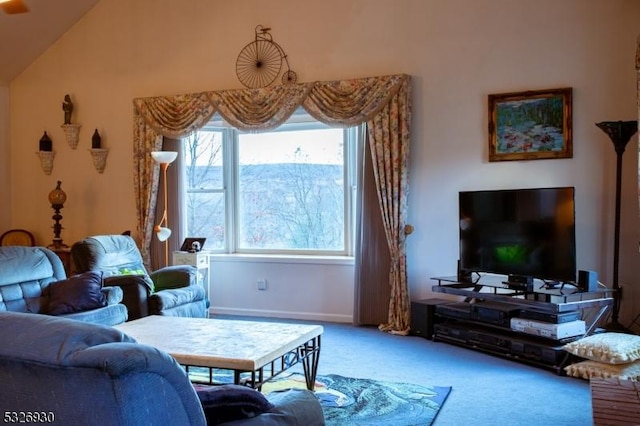 carpeted living room with high vaulted ceiling