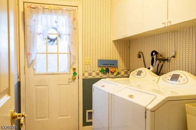 laundry area featuring cabinets and independent washer and dryer