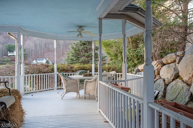 wooden terrace featuring ceiling fan