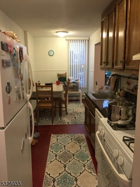 kitchen featuring sink and white appliances