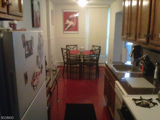 kitchen featuring white appliances and sink