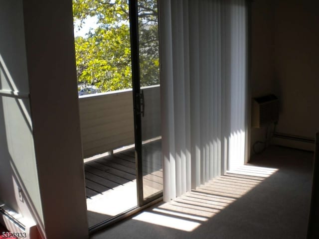 room details with an AC wall unit and a baseboard radiator