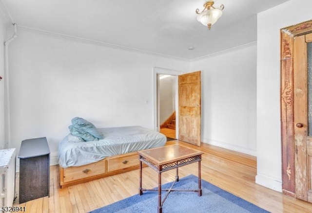 bedroom featuring hardwood / wood-style flooring and ornamental molding