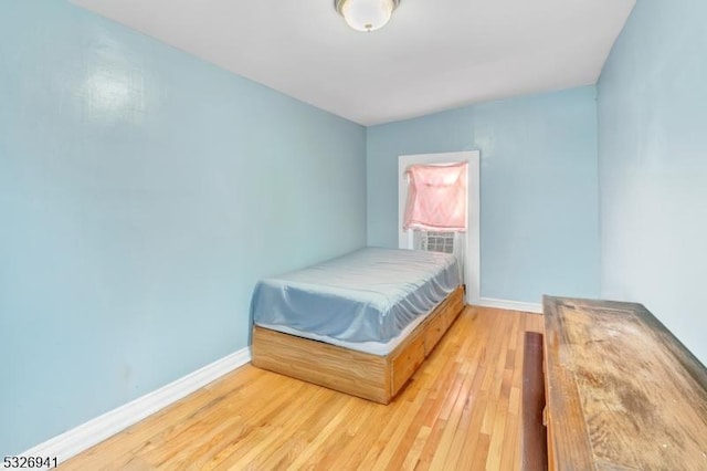 bedroom with hardwood / wood-style floors