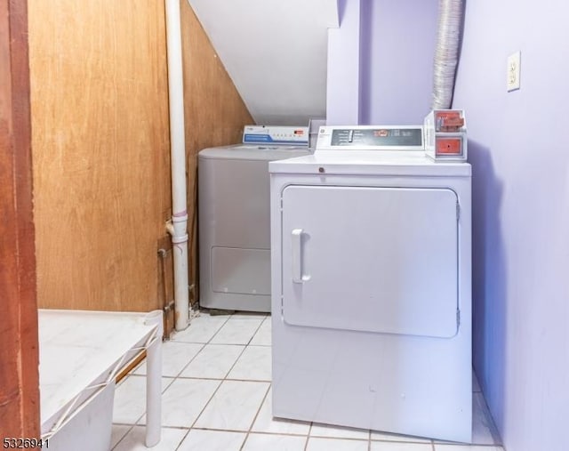 laundry room featuring washer and dryer and light tile patterned floors