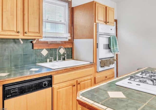 kitchen with white appliances, backsplash, and sink