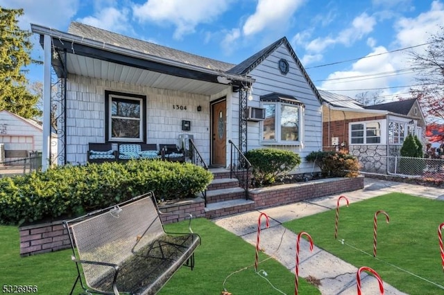 bungalow-style house with a front lawn and a porch