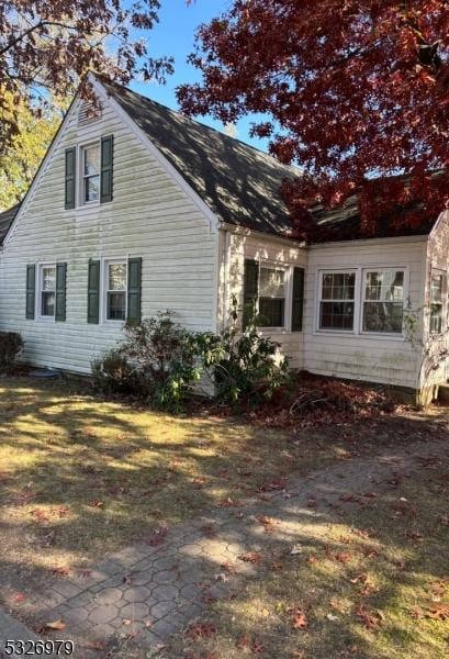 view of side of home featuring a lawn