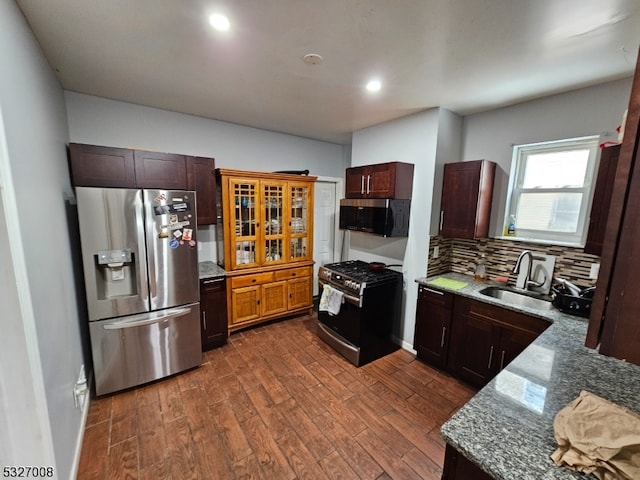 kitchen with sink, light stone counters, dark hardwood / wood-style floors, backsplash, and appliances with stainless steel finishes