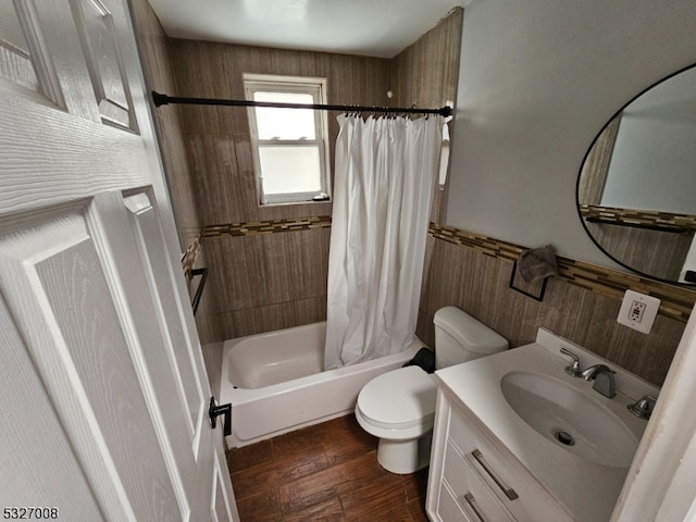 full bathroom with shower / bath combo with shower curtain, vanity, hardwood / wood-style floors, and toilet