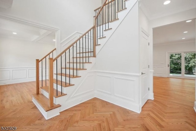 stairs featuring parquet flooring and ornamental molding