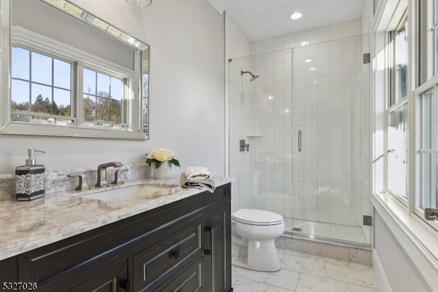 bathroom featuring walk in shower, vanity, and toilet