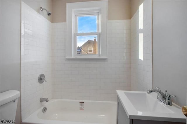 full bathroom featuring vanity, toilet, and tiled shower / bath