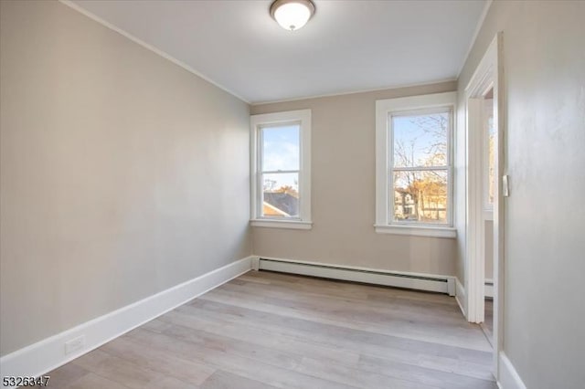 spare room with light hardwood / wood-style flooring and a baseboard heating unit