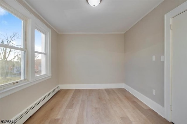 unfurnished room with crown molding, light hardwood / wood-style flooring, and a baseboard radiator