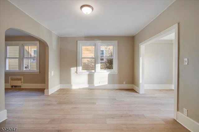 interior space with radiator heating unit and light wood-type flooring