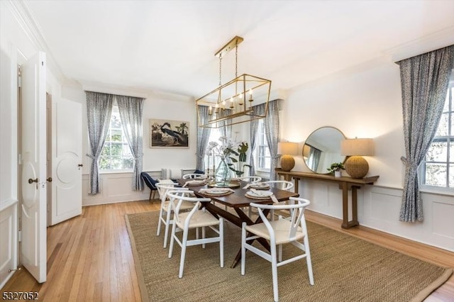 dining room featuring light wood-type flooring and an inviting chandelier