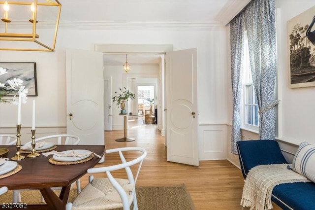 interior space with ornamental molding and light hardwood / wood-style flooring