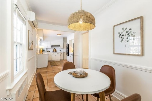 dining area featuring ornamental molding, light tile patterned floors, and a wall unit AC