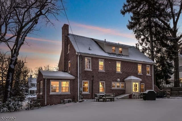 view of snow covered back of property