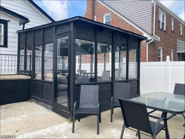 view of patio featuring a sunroom