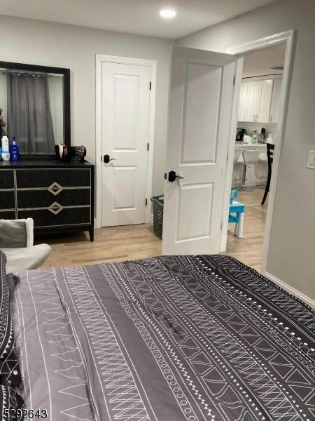 bedroom featuring hardwood / wood-style floors and a closet