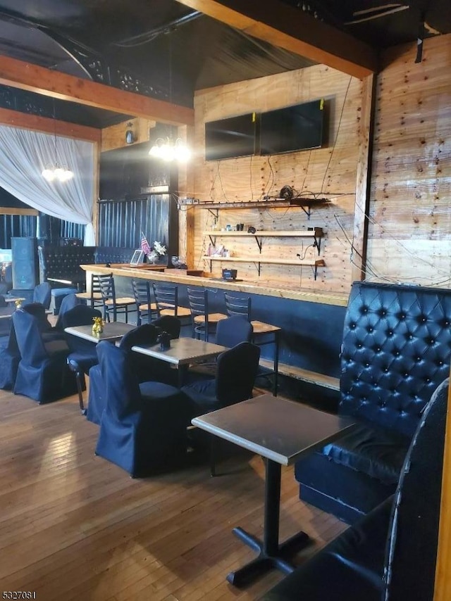 recreation room with wood walls and wood-type flooring