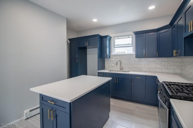 kitchen featuring tasteful backsplash, sink, a baseboard radiator, a kitchen island, and stainless steel range with gas stovetop