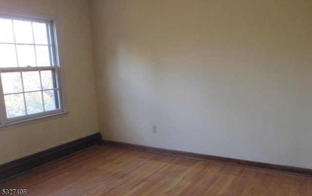 spare room with hardwood / wood-style floors