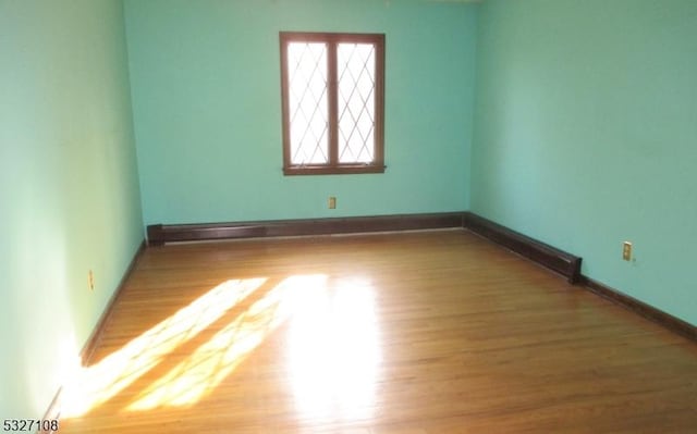 spare room with hardwood / wood-style floors