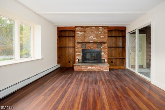 unfurnished living room featuring built in shelves, a baseboard radiator, dark hardwood / wood-style floors, and a wood stove