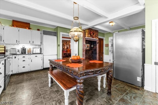 kitchen featuring decorative backsplash, white cabinetry, beamed ceiling, and paneled built in fridge