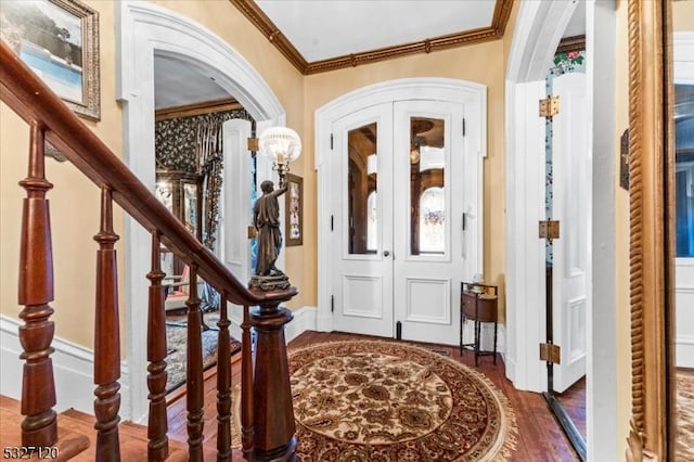 entryway featuring crown molding, french doors, and dark wood-type flooring