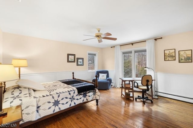 bedroom featuring hardwood / wood-style flooring and baseboard heating