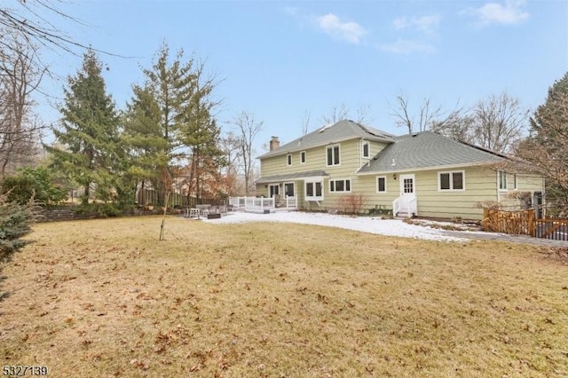 rear view of property with a patio and a lawn