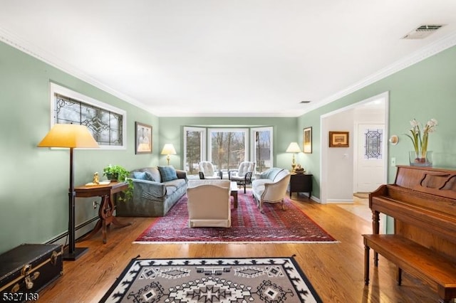 living room featuring ornamental molding and light wood-type flooring