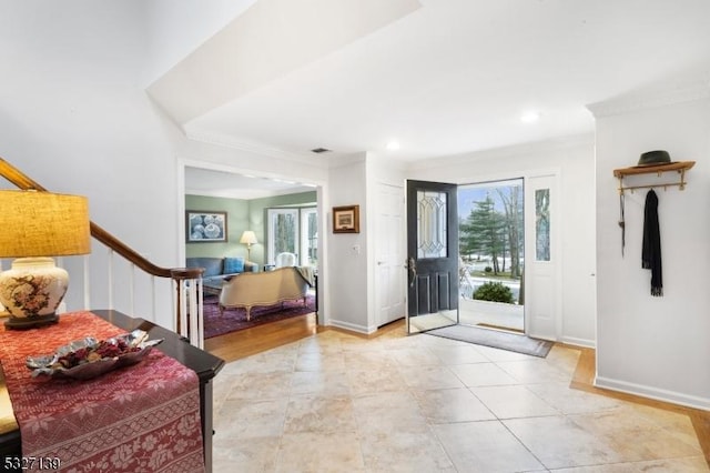 foyer featuring crown molding