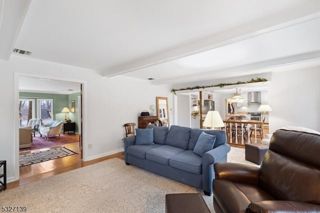 living room featuring beamed ceiling and parquet floors