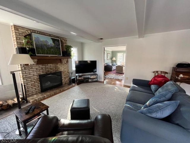 living room with beamed ceiling and a brick fireplace