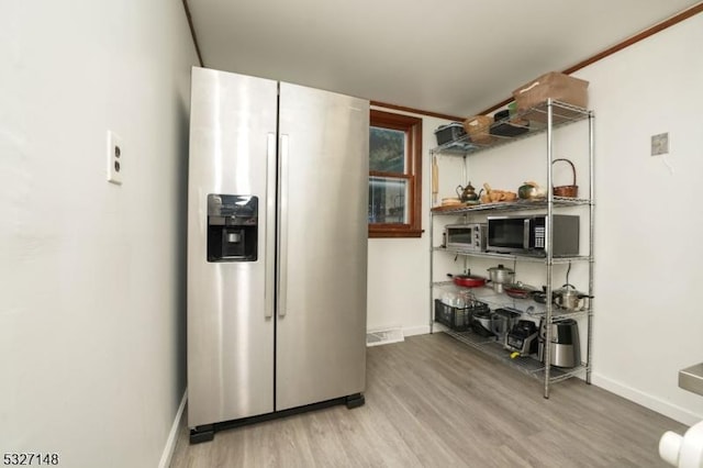 kitchen featuring hardwood / wood-style floors and appliances with stainless steel finishes