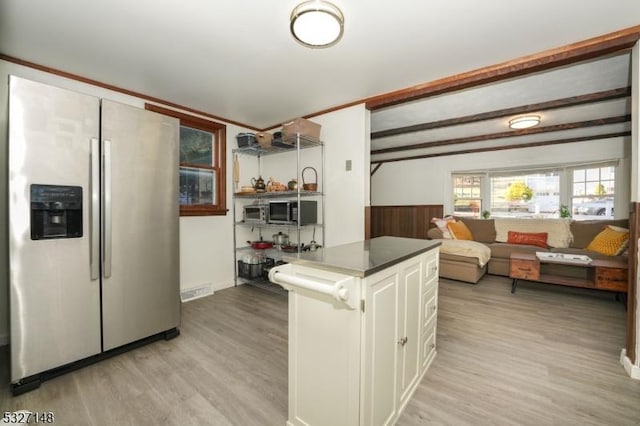 kitchen with white cabinetry, light wood-type flooring, and stainless steel fridge with ice dispenser