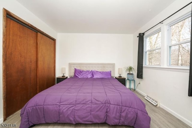 bedroom featuring a closet and light hardwood / wood-style flooring